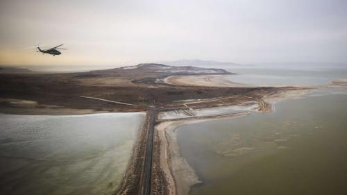 A Blackhawk helicopter flies over the Great Salt Lake as Utah lawmakers take an aerial tour of the lake with the Utah Army National Guard on Feb. 15. Utah experts project the lake will fall another 2 feet below the record low set last year. (Scott G. Winterton)